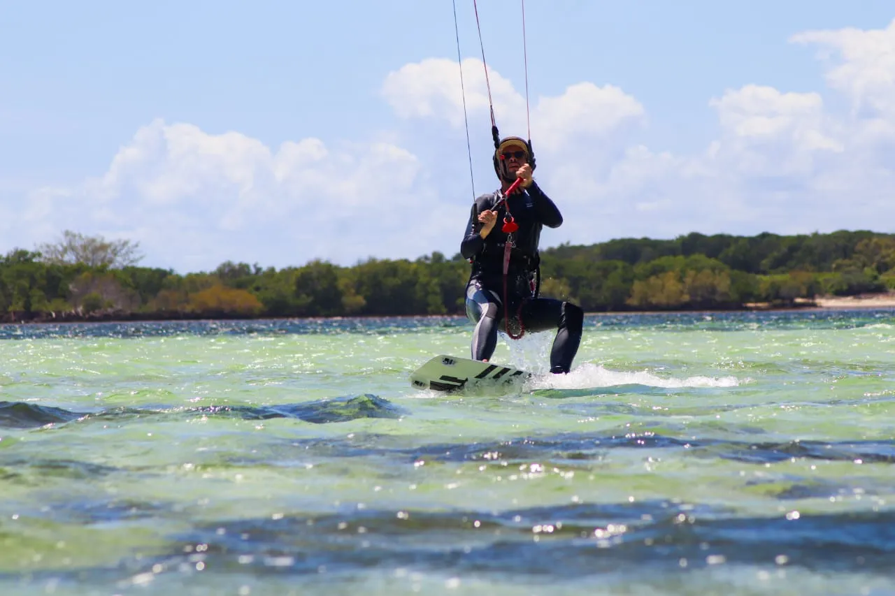 Kitesurfer cruising on turquoise water